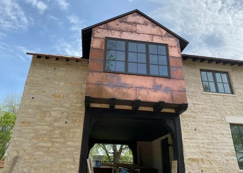 Copper metal panel facade on a stone building for Skylight Installation in North Little Rock